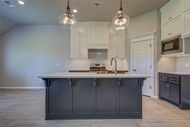 9120 NW 123rd St, Yukon, OK 73099 - kitchen featuring black microwave, stainless steel range oven, light countertops, light wood finished floors, and recessed lighting