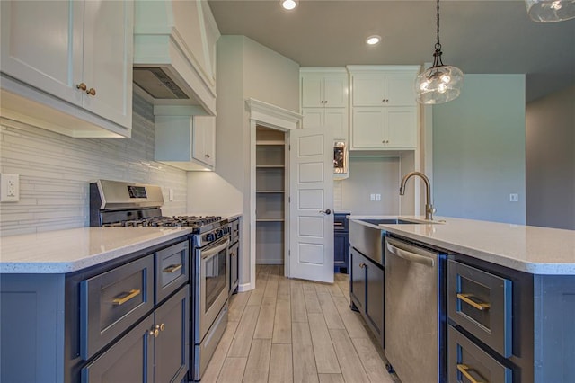 9120 NW 123rd St, Yukon, OK 73099 - kitchen featuring appliances with stainless steel finishes, white cabinets, recessed lighting, light wood-style floors, and light stone countertops