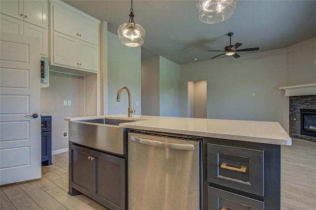 9120 NW 123rd St, Yukon, OK 73099 - kitchen featuring dishwasher, light wood-style floors, a ceiling fan, and open floor plan