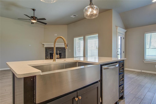 9120 NW 123rd St, Yukon, OK 73099 - kitchen with dishwasher, a fireplace, light wood-type flooring, ceiling fan, and pendant lighting