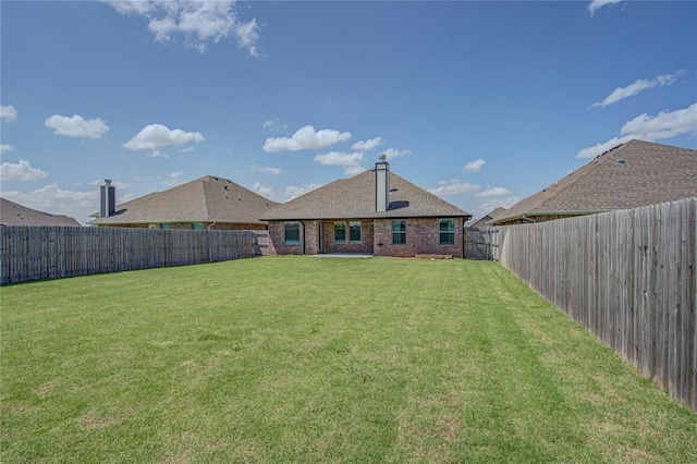 9120 NW 123rd St, Yukon, OK 73099 - rear view of property featuring brick siding and a fenced backyard
