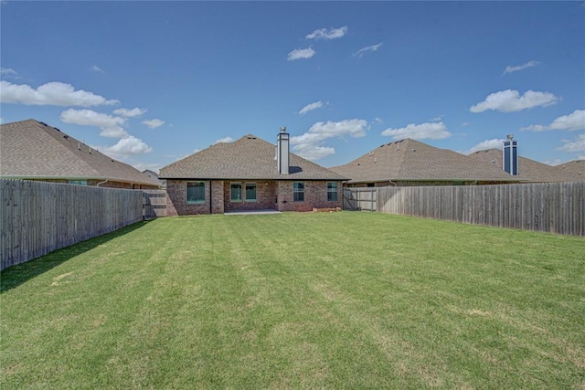 9120 NW 123rd St, Yukon, OK 73099 - rear view of house featuring brick siding and a fenced backyard