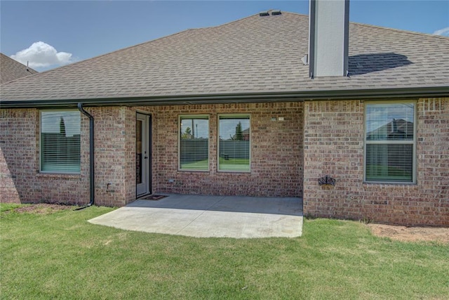 9120 NW 123rd St, Yukon, OK 73099 - rear view of house with roof with shingles, a lawn, a chimney, and brick siding