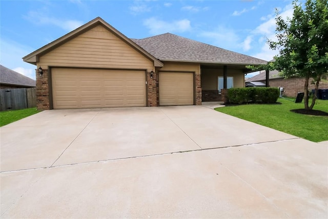 10928 NW 38th Ter, Yukon, OK 73099 - view of front of property with brick siding, a front yard, driveway, a garage, and roof with shingles