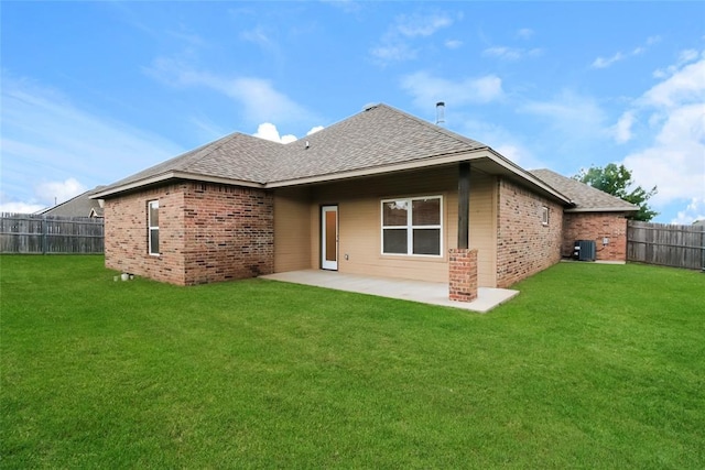 10928 NW 38th Ter, Yukon, OK 73099 - back of property featuring brick siding, roof with shingles, a fenced backyard, and a patio