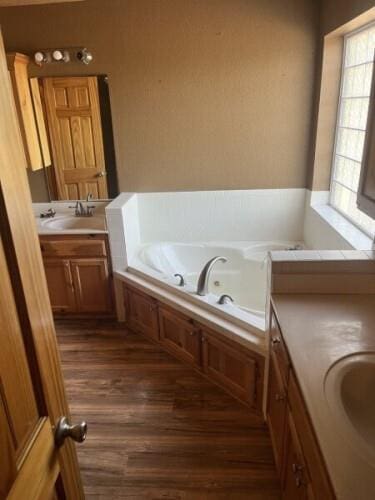 14001 NE 150th St, Jones, OK 73049 - full bathroom with wood finished floors, a jetted tub, and vanity