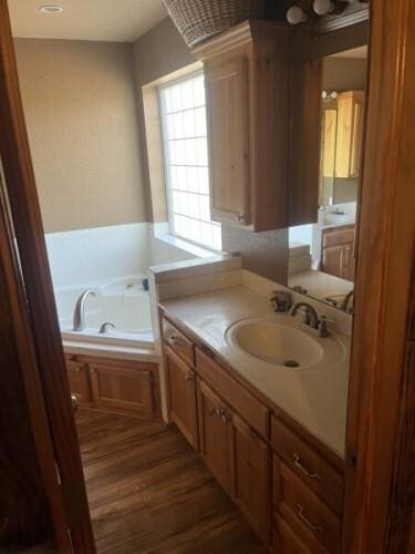 14001 NE 150th St, Jones, OK 73049 - bathroom featuring a bath, wood finished floors, and vanity