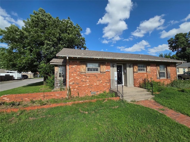 1103 S Hadden Ave, El Reno, OK 73036 - view of front of property featuring brick siding, a front yard, and crawl space