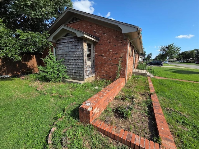 1103 S Hadden Ave, El Reno, OK 73036 - view of home's exterior featuring brick siding