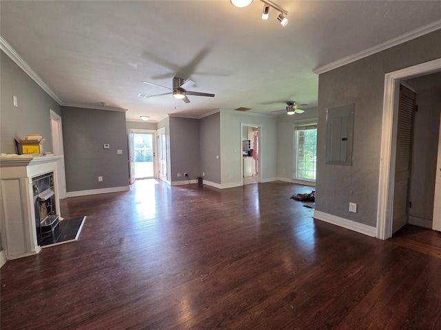 1103 S Hadden Ave, El Reno, OK 73036 - unfurnished living room with electric panel, ceiling fan, plenty of natural light, dark wood-type flooring, and ornamental molding