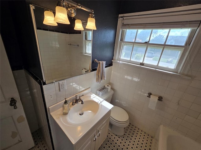 1103 S Hadden Ave, El Reno, OK 73036 - bathroom with tile walls, a shower, vanity, a bathtub, and a wainscoted wall