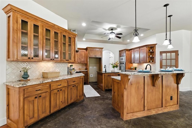 15016 Kurdson Way, Edmond, OK 73013 - kitchen featuring appliances with stainless steel finishes, open shelves, a kitchen bar, a tray ceiling, and recessed lighting