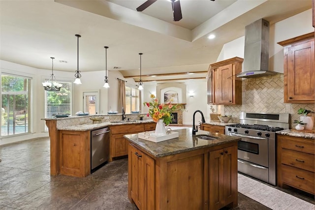 15016 Kurdson Way, Edmond, OK 73013 - kitchen featuring wall chimney exhaust hood, stainless steel appliances, a center island with sink, brown cabinets, and recessed lighting