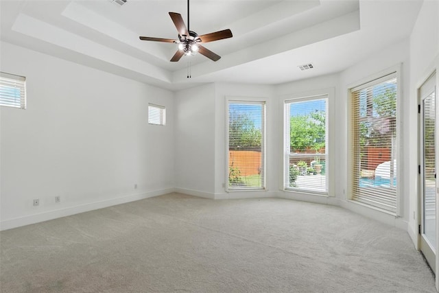 15016 Kurdson Way, Edmond, OK 73013 - unfurnished room featuring a tray ceiling, carpet flooring, and ceiling fan