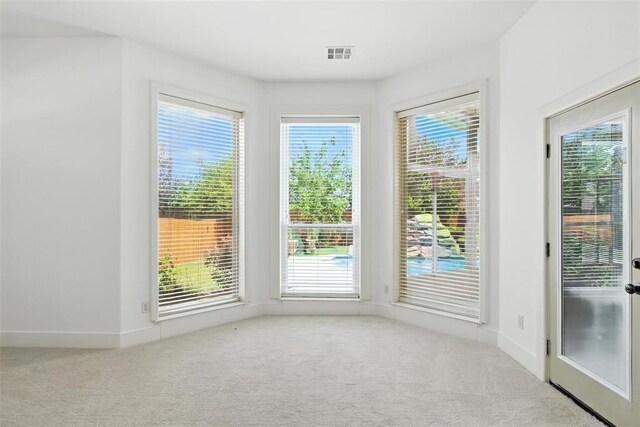 15016 Kurdson Way, Edmond, OK 73013 - empty room with carpet floors and plenty of natural light