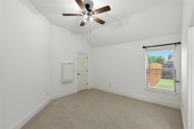 15016 Kurdson Way, Edmond, OK 73013 - empty room with light colored carpet, vaulted ceiling, and a ceiling fan
