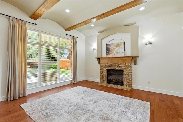15016 Kurdson Way, Edmond, OK 73013 - living area featuring beam ceiling, a stone fireplace, wood finished floors, and recessed lighting