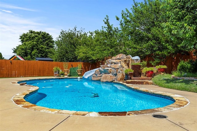 15016 Kurdson Way, Edmond, OK 73013 - view of pool with a water slide, a fenced backyard, and a patio area
