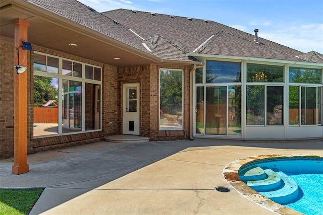 15016 Kurdson Way, Edmond, OK 73013 - rear view of house featuring a patio, a shingled roof, and an outdoor pool