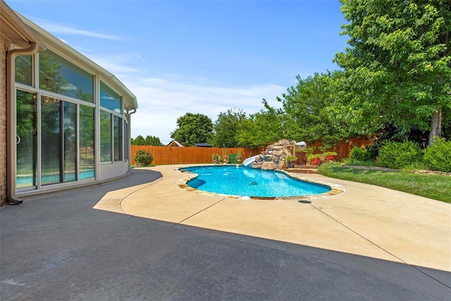 15016 Kurdson Way, Edmond, OK 73013 - view of pool with a water slide, a patio, and a fenced backyard