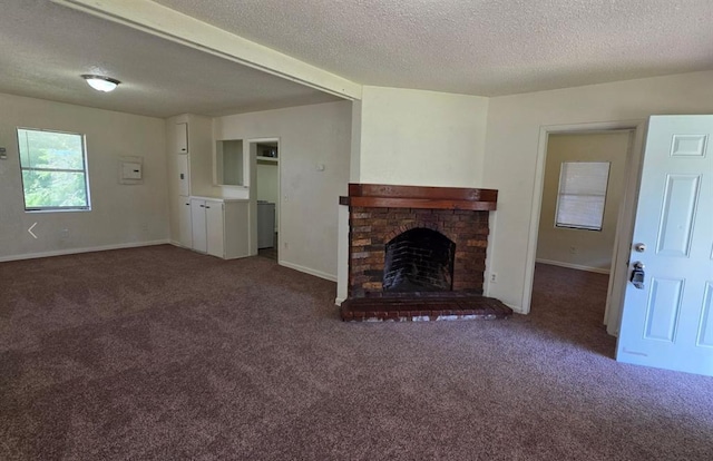 1325 SW 28th St, Oklahoma City, OK 73108 - unfurnished living room featuring carpet flooring, a fireplace, and a textured ceiling