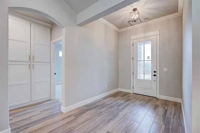 13337 SE 95th St, Oklahoma City, OK 73165 - entryway featuring crown molding, arched walkways, light wood-style flooring, and a chandelier
