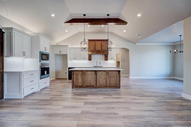 13337 SE 95th St, Oklahoma City, OK 73165 - kitchen with stainless steel oven, a chandelier, black microwave, a center island with sink, and light countertops