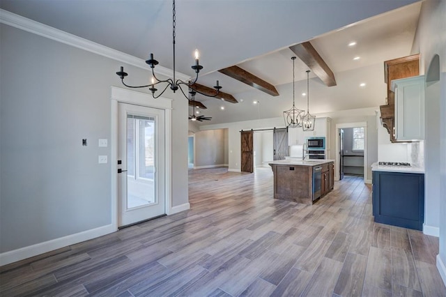 13337 SE 95th St, Oklahoma City, OK 73165 - kitchen featuring a barn door, built in microwave, open floor plan, light countertops, and a chandelier