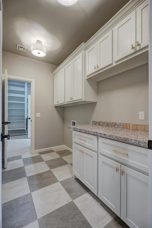 13337 SE 95th St, Oklahoma City, OK 73165 - laundry area featuring cabinet space, light flooring, and washer hookup