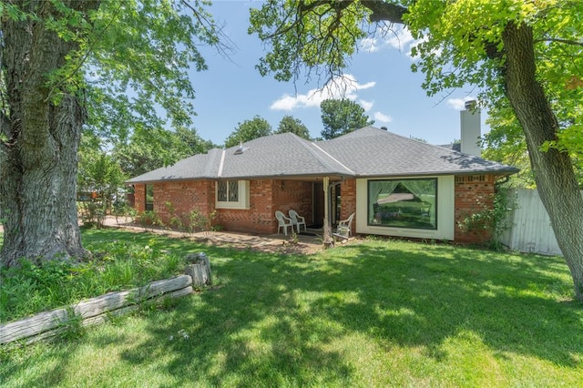 1404 Oak Dr, Edmond, OK 73034 - rear view of house with a chimney, a patio area, and brick siding