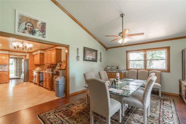 1404 Oak Dr, Edmond, OK 73034 - dining area with lofted ceiling, crown molding, light wood-style flooring, a ceiling fan, and a chandelier