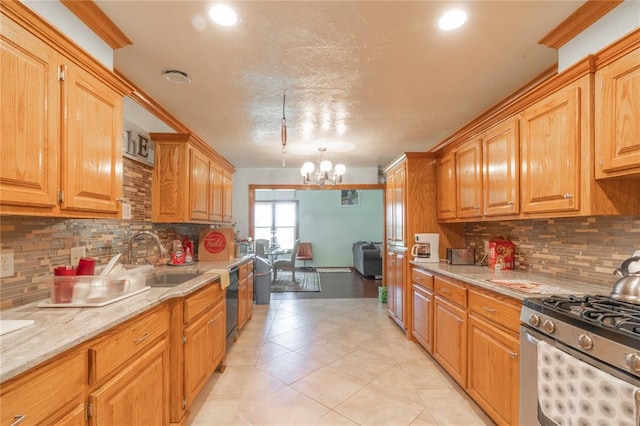 1404 Oak Dr, Edmond, OK 73034 - kitchen featuring tasteful backsplash, a chandelier, stainless steel gas range oven, light tile patterned floors, and a textured ceiling