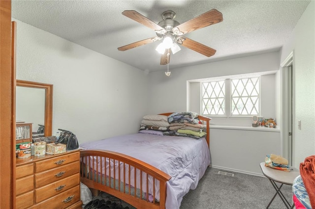 1404 Oak Dr, Edmond, OK 73034 - bedroom featuring carpet floors, a ceiling fan, and a textured ceiling
