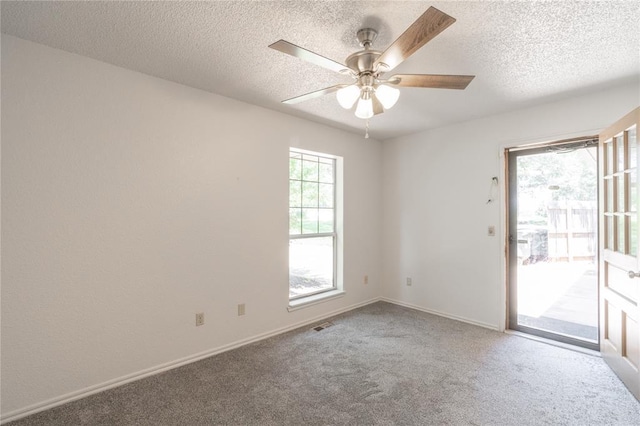 1404 Oak Dr, Edmond, OK 73034 - carpeted spare room with a textured ceiling and a ceiling fan