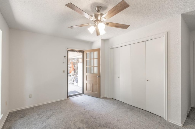 1404 Oak Dr, Edmond, OK 73034 - unfurnished bedroom with carpet, a textured ceiling, a closet, ceiling fan, and access to exterior