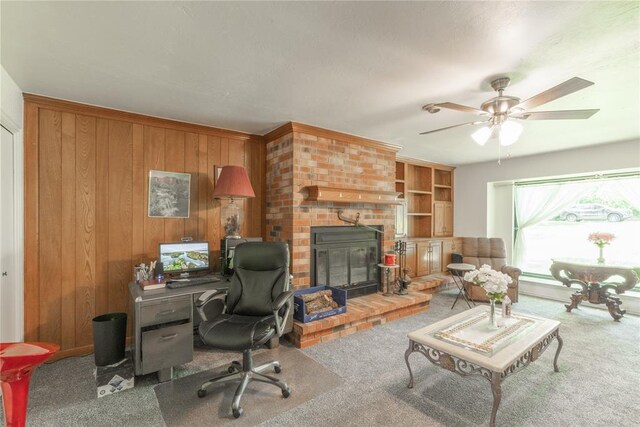 1404 Oak Dr, Edmond, OK 73034 - carpeted office featuring wooden walls, a fireplace, and a ceiling fan