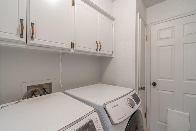 1404 Oak Dr, Edmond, OK 73034 - washroom with separate washer and dryer, cabinet space, and a textured wall