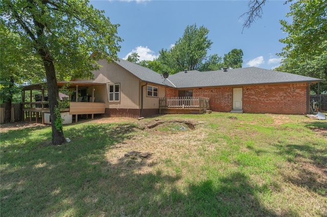 1404 Oak Dr, Edmond, OK 73034 - rear view of house with a wooden deck, a yard, and brick siding