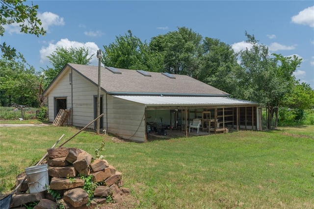 1404 Oak Dr, Edmond, OK 73034 - rear view of property featuring a lawn, a shingled roof, and an outdoor structure