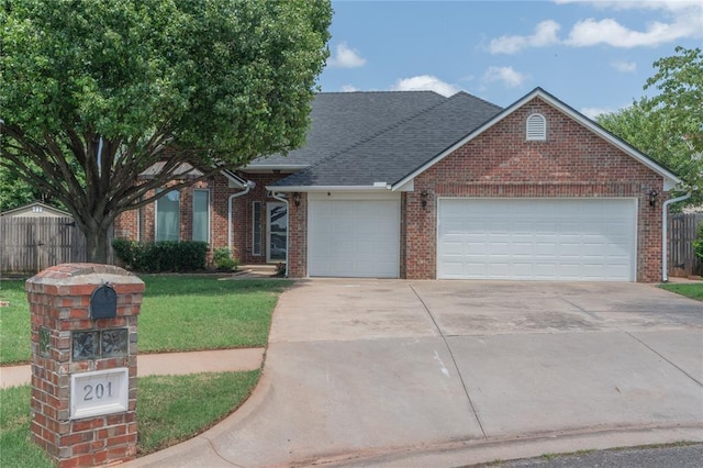 201 NW 160th Ter, Edmond, OK 73013 - view of front of house featuring brick siding, driveway, a garage, and a shingled roof