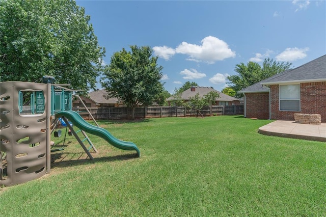 201 NW 160th Ter, Edmond, OK 73013 - fenced backyard featuring a playground and a patio