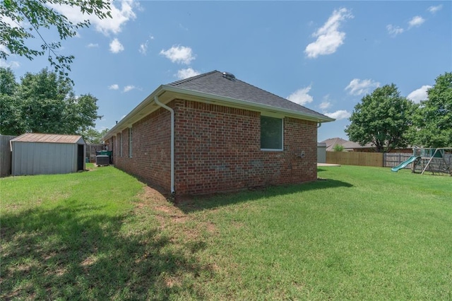201 NW 160th Ter, Edmond, OK 73013 - view of home's exterior featuring a playground, a shed, and brick siding