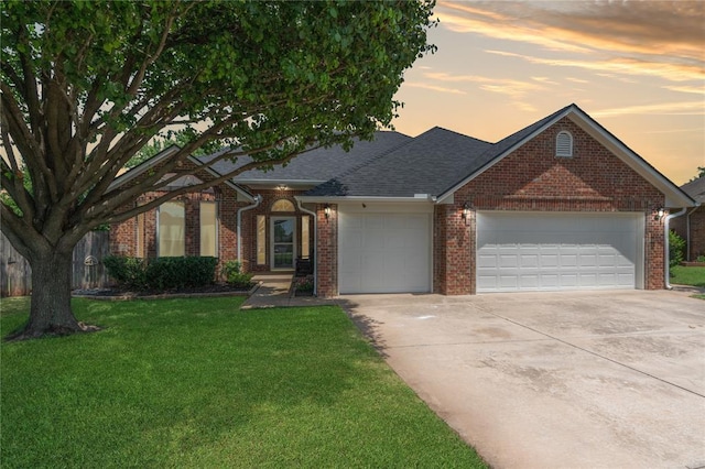201 NW 160th Ter, Edmond, OK 73013 - traditional home with an attached garage, brick siding, a yard, concrete driveway, and a shingled roof