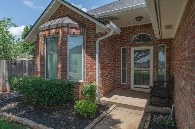 201 NW 160th Ter, Edmond, OK 73013 - view of exterior entry with brick siding and a shingled roof