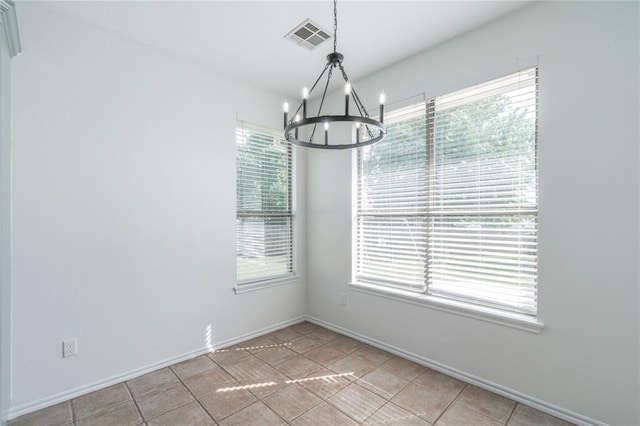 201 NW 160th Ter, Edmond, OK 73013 - unfurnished dining area with a chandelier and light tile patterned floors