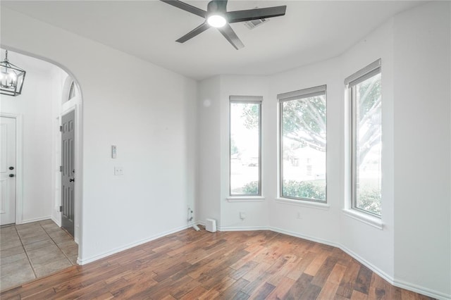 201 NW 160th Ter, Edmond, OK 73013 - unfurnished room with plenty of natural light, wood finished floors, and arched walkways