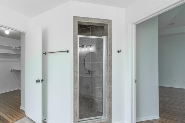 201 NW 160th Ter, Edmond, OK 73013 - full bath featuring a spacious closet, a shower stall, and wood finished floors