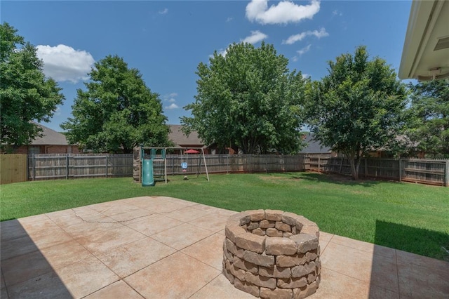 201 NW 160th Ter, Edmond, OK 73013 - fenced backyard with a fire pit, a patio area, and a playground