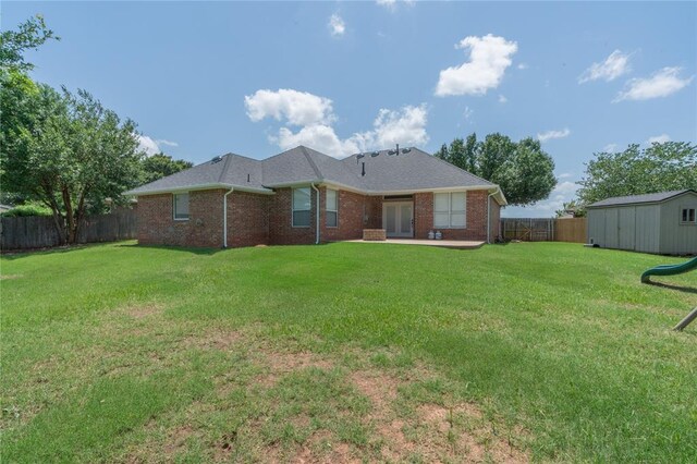 201 NW 160th Ter, Edmond, OK 73013 - back of house featuring a fenced backyard, brick siding, a shed, and french doors