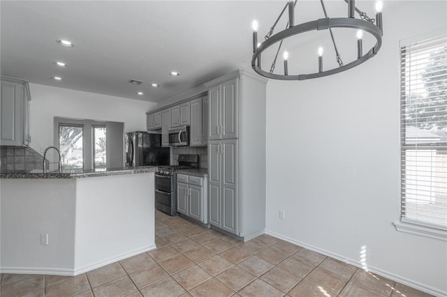 201 NW 160th Ter, Edmond, OK 73013 - kitchen with stainless steel appliances, gray cabinetry, tasteful backsplash, stone counters, and recessed lighting